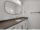 Stylish bathroom with gray quartz countertops, modern gold fixtures, and an oval mirror creating an elegant space at 65 Cherry Bark Dr, Youngsville, NC 27596