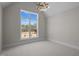 Bright, airy bedroom with carpeted floors, large window, and modern lighting at 65 Cherry Bark Dr, Youngsville, NC 27596