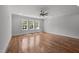 Spacious bedroom featuring hardwood floors and large windows offering scenic views and natural light at 65 Cherry Bark Dr, Youngsville, NC 27596