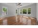 Bright bedroom featuring hardwood floors and large windows offering scenic views and natural light at 65 Cherry Bark Dr, Youngsville, NC 27596