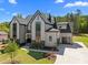 Stunning exterior view of modern two-story home featuring black-framed windows, a garage and a beautiful lawn at 65 Cherry Bark Dr, Youngsville, NC 27596