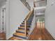 Grand foyer with hardwood floors and modern staircase showcasing architectural details and design at 65 Cherry Bark Dr, Youngsville, NC 27596
