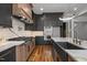 Modern kitchen featuring gray cabinets, marble countertops, stainless steel appliances, and hardwood floors at 65 Cherry Bark Dr, Youngsville, NC 27596