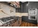 Stylish kitchen with gray cabinetry, marble backsplash, a pro-style range, and stainless steel double ovens at 65 Cherry Bark Dr, Youngsville, NC 27596