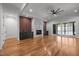 Open-plan living area with a fireplace, hardwood floors, sliding doors and a fan at 65 Cherry Bark Dr, Youngsville, NC 27596