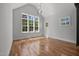 Bright, spacious living area with hardwood floors, large windows and neutral paint at 65 Cherry Bark Dr, Youngsville, NC 27596