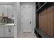 Mudroom features gray cabinets, a gold faucet, a door to the garage, and a black storage bench at 65 Cherry Bark Dr, Youngsville, NC 27596