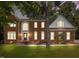 Charming brick two-story home with manicured lawn and elegant arched entryway at 111 N Coslett Ct, Cary, NC 27513