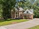Charming brick two-story home with a long driveway and well-manicured front lawn at 111 N Coslett Ct, Cary, NC 27513