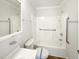 Clean bathroom featuring a shower-tub combo with grab bars for accessibility at 225 W Orange St, Hillsborough, NC 27278