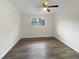 Bright bedroom with a ceiling fan, wood-look flooring, neutral walls, and a window for natural light at 225 W Orange St, Hillsborough, NC 27278