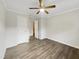 A bright bedroom with a ceiling fan and new flooring creates a comfortable space at 225 W Orange St, Hillsborough, NC 27278