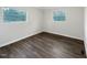 The bedroom has hard surface floors, neutral paint, and two windows for natural light at 225 W Orange St, Hillsborough, NC 27278
