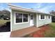 Charming exterior view of a light green house, with white trim and a well-manicured lawn at 225 W Orange St, Hillsborough, NC 27278