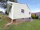 Exterior of the home shows updated siding, foundation and an air conditioning unit at 225 W Orange St, Hillsborough, NC 27278