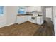 Updated kitchen featuring white cabinets and countertops, updated appliances, and stainless steel sink at 225 W Orange St, Hillsborough, NC 27278