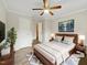 Serene main bedroom with modern furniture, ceiling fan, and soft, natural lighting at 225 W Orange St, Hillsborough, NC 27278