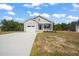 Charming single-story home with neutral siding, attached garage, and freshly poured concrete driveway at 63 Falls River Ct, Broadway, NC 27505