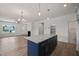 Open kitchen with blue island and view into living room at 63 Falls River Ct, Broadway, NC 27505