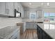 Modern kitchen with granite countertops and stainless steel appliances at 63 Falls River Ct, Broadway, NC 27505