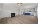 Spacious open-concept living room featuring a fireplace and hardwood flooring at 63 Falls River Ct, Broadway, NC 27505