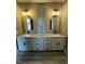 Elegant bathroom with double vanity, granite countertops, modern lighting, and wood flooring at 2829 Faucette Ln, Burlington, NC 27217
