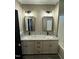 Bright bathroom with dual sinks, granite countertops, modern fixtures, and dark accents at 2829 Faucette Ln, Burlington, NC 27217