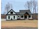 Charming single-Gathering home featuring black trim, a covered porch, and a well-manicured front yard at 2829 Faucette Ln, Burlington, NC 27217