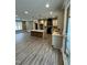Open concept kitchen with an island, modern cabinetry, stylish pendant lights, and wood flooring at 2829 Faucette Ln, Burlington, NC 27217