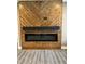Living room features a fireplace with custom wood surround and gray wood-look floors at 2829 Faucette Ln, Burlington, NC 27217