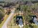 An aerial view of the home showcasing the neighborhood and surrounding wooded area at 100 Carol Cir, Louisburg, NC 27549