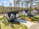 Beautiful aerial view of the home, its spacious driveway, and the surrounding lush landscape at 100 Carol Cir, Louisburg, NC 27549