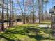 A large, level backyard featuring well-maintained green grass and a small utility shed at 100 Carol Cir, Louisburg, NC 27549