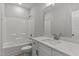 Bright, white bathroom with a tub/shower and vanity with white quartz countertop at 100 Carol Cir, Louisburg, NC 27549