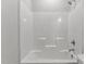 A clean and standard white bathtub and shower combo with a shower head, and shower handle at 100 Carol Cir, Louisburg, NC 27549