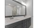 Bathroom featuring a double vanity with gray cabinets and a large mirror at 100 Carol Cir, Louisburg, NC 27549