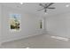 Spacious, well-lit carpeted bedroom with neutral paint and ceiling fan at 100 Carol Cir, Louisburg, NC 27549