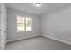 Small bedroom with carpeted floor and a single window at 100 Carol Cir, Louisburg, NC 27549