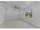 A bright carpeted room with a window, ceiling fan, recessed lights and light grey walls at 100 Carol Cir, Louisburg, NC 27549