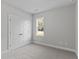 A small bedroom with carpet, a double door closet, window, and light grey walls at 100 Carol Cir, Louisburg, NC 27549