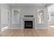 Close up on the white fireplace with windows on either side of the mantel at 100 Carol Cir, Louisburg, NC 27549