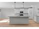 Spacious kitchen features granite counters, white cabinetry, an island with pendant lighting, and modern appliances at 100 Carol Cir, Louisburg, NC 27549