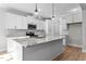 Modern kitchen with white cabinetry, granite countertops, stainless steel appliances, and center island at 100 Carol Cir, Louisburg, NC 27549