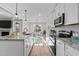 Modern kitchen with white cabinetry, granite countertops, stainless steel appliances, and an island with pendant lighting at 100 Carol Cir, Louisburg, NC 27549