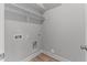 A small laundry area with washer and dryer hookups with off-white walls and trim at 100 Carol Cir, Louisburg, NC 27549