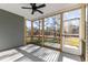 A screened in back porch with railings, ceiling fan, and a view of the yard and neighborhood at 100 Carol Cir, Louisburg, NC 27549