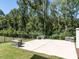 Backyard patio area with stone benches and a wooded perimeter at 123 Cottage Way, Pittsboro, NC 27312