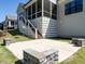 A view of the home's backyard patio with stone benches, as well as the screened-in porch at 123 Cottage Way, Pittsboro, NC 27312