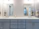 Bright bathroom features double vanity with modern fixtures, sinks, and large mirrors, providing ample space at 123 Cottage Way, Pittsboro, NC 27312