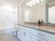 Bathroom with granite vanity, shower over tub, and modern light fixture at 123 Cottage Way, Pittsboro, NC 27312